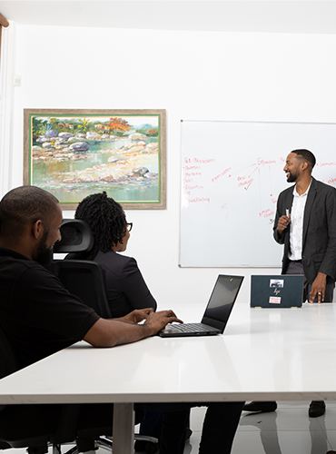 A meeting with a presenter at a whiteboard